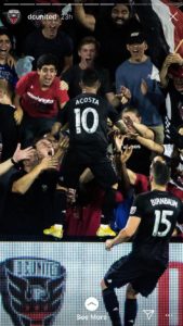 fans at a D.C. United soccer game, cheering