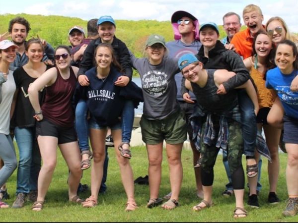 Group of students and professors standing outdoors at biological center