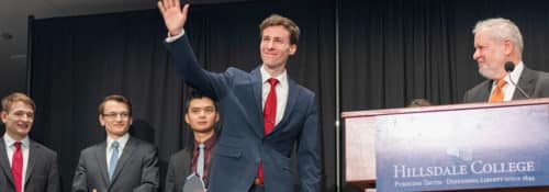 Well-dressed Hillsdale students on stage after presenting their oratories