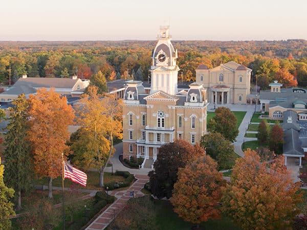 an aerial view of campus with orange and gold foliage