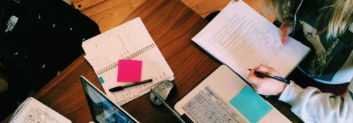 books and computers on table for studying