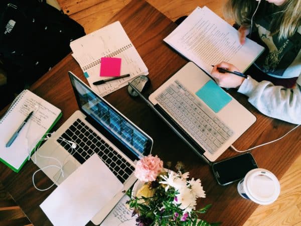 books and computers on table for studying