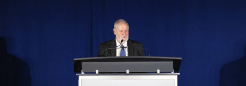 Larry Arnn at a podium speaking before an audience