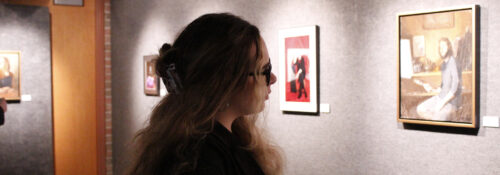 A student looking at a painting
