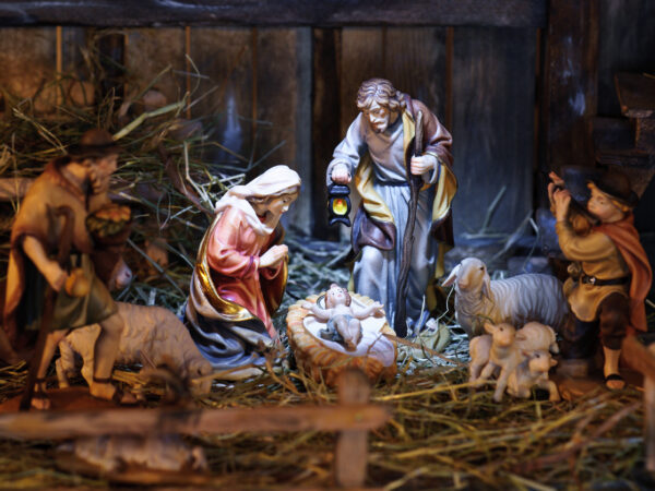 nativity scene with hand-colored figures made out of wood