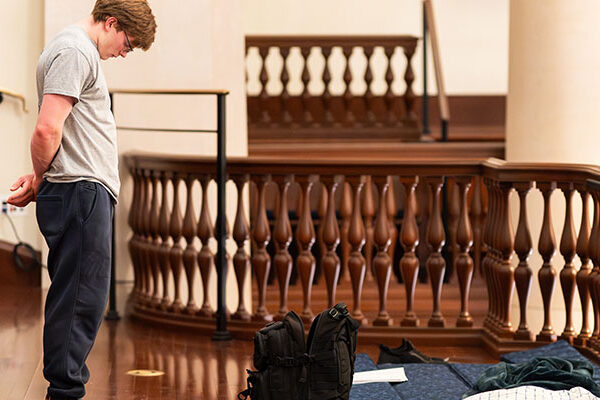 A retreat participant bows his head in prayer.