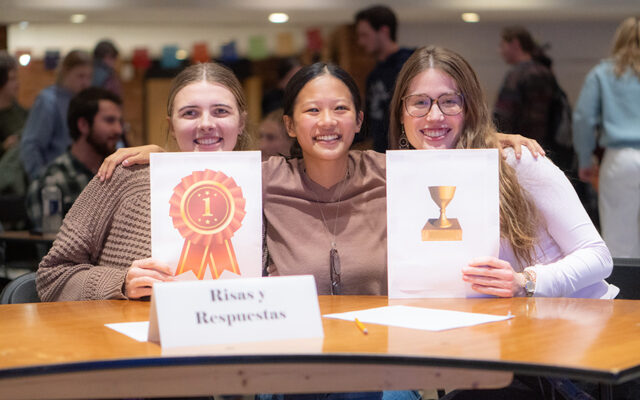 3 women holding paper trophies